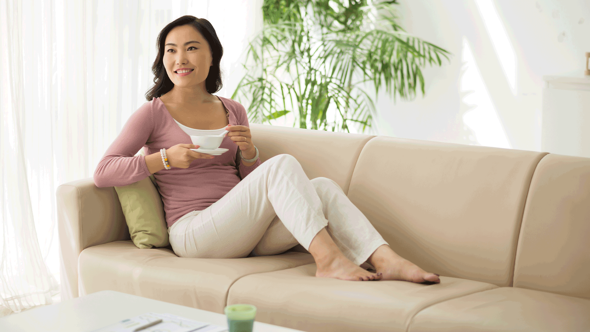 happy woman with menopause sitting on the couch